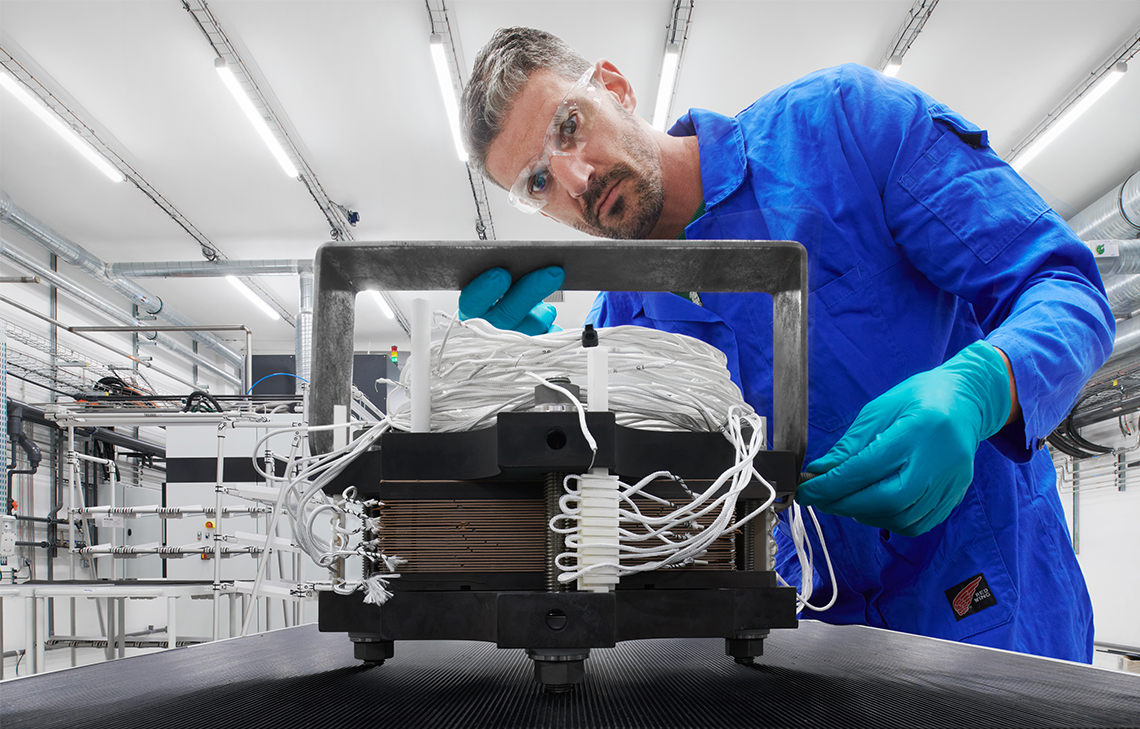 Engineer looking at a piece of an equipment in a manufacturing facility, Beziers. (Tier 1_ManufacturingFacility_Beziers_OAT_ 15212)