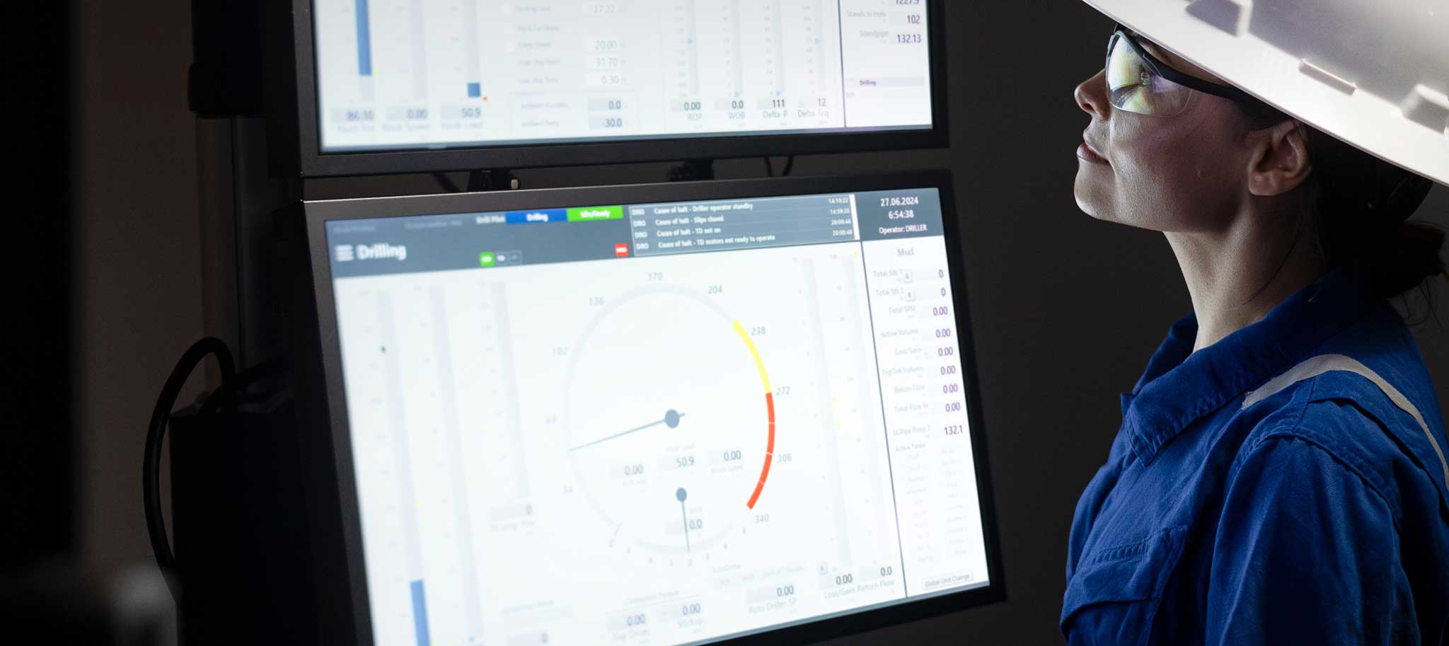 woman looking at 2 computer screens