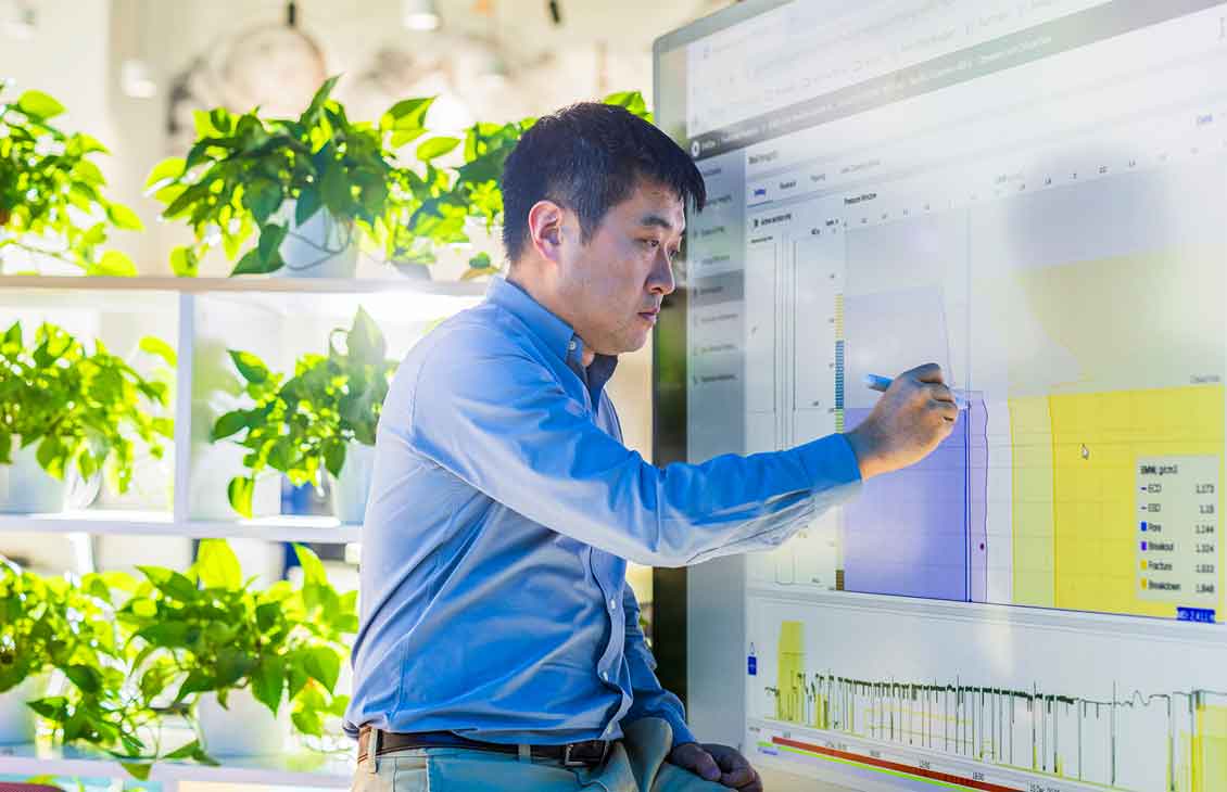 man writing on white board