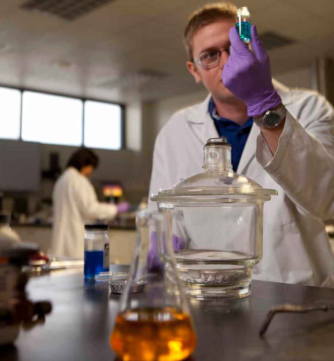 Worker looking at halide brines in laboratory