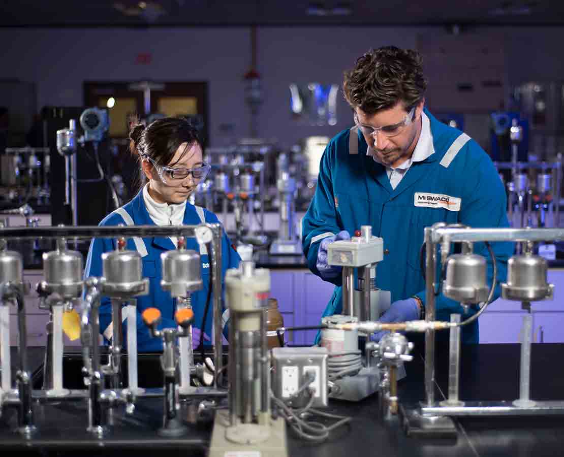 Schlumberger workers in the lab