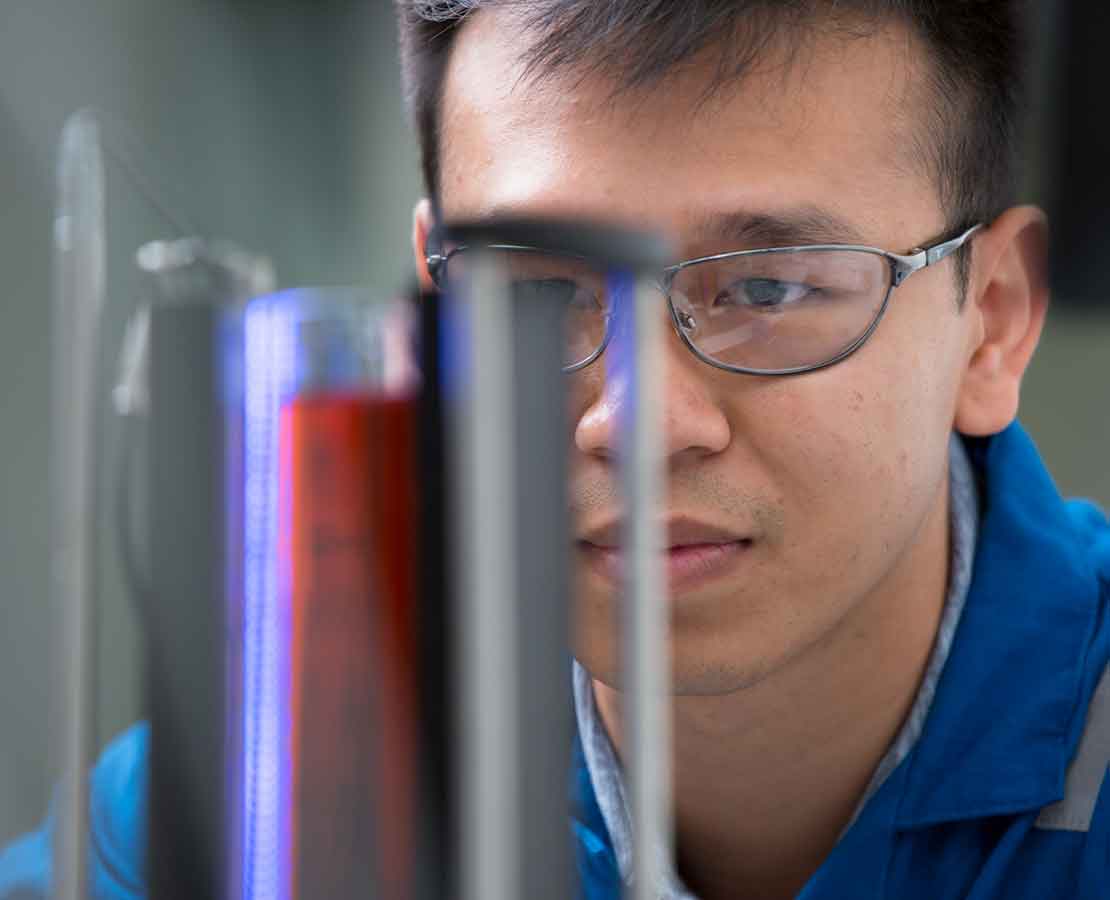 Scale inhibitors with worker in lab