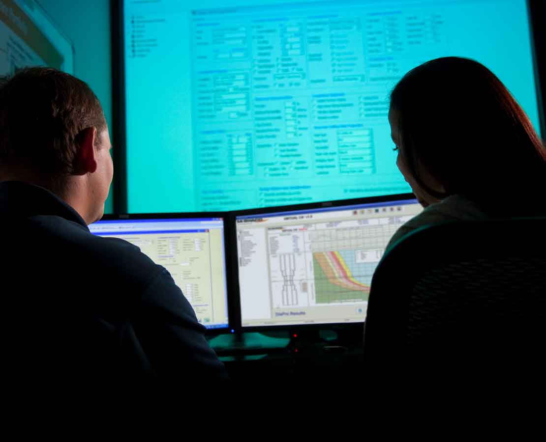 Schlumberger workers evaluating a displacement