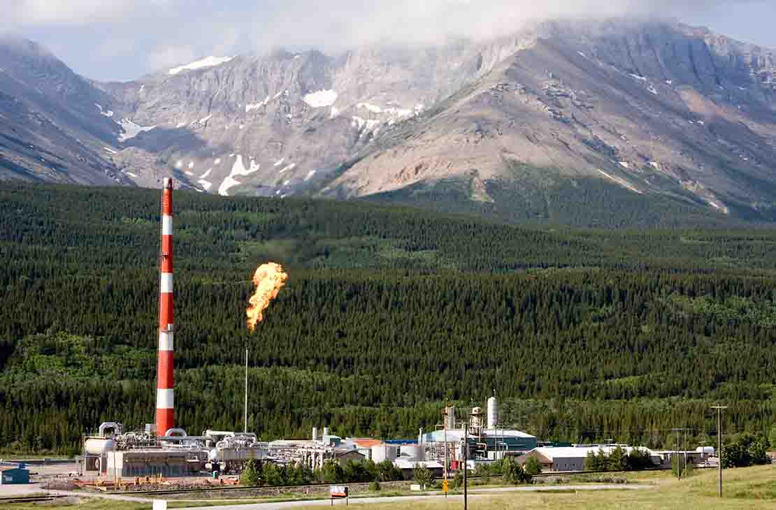 Rig in front of mountains.