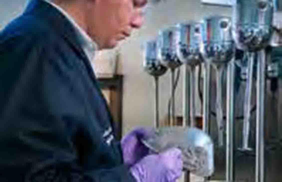 Man in laboratory performing test.