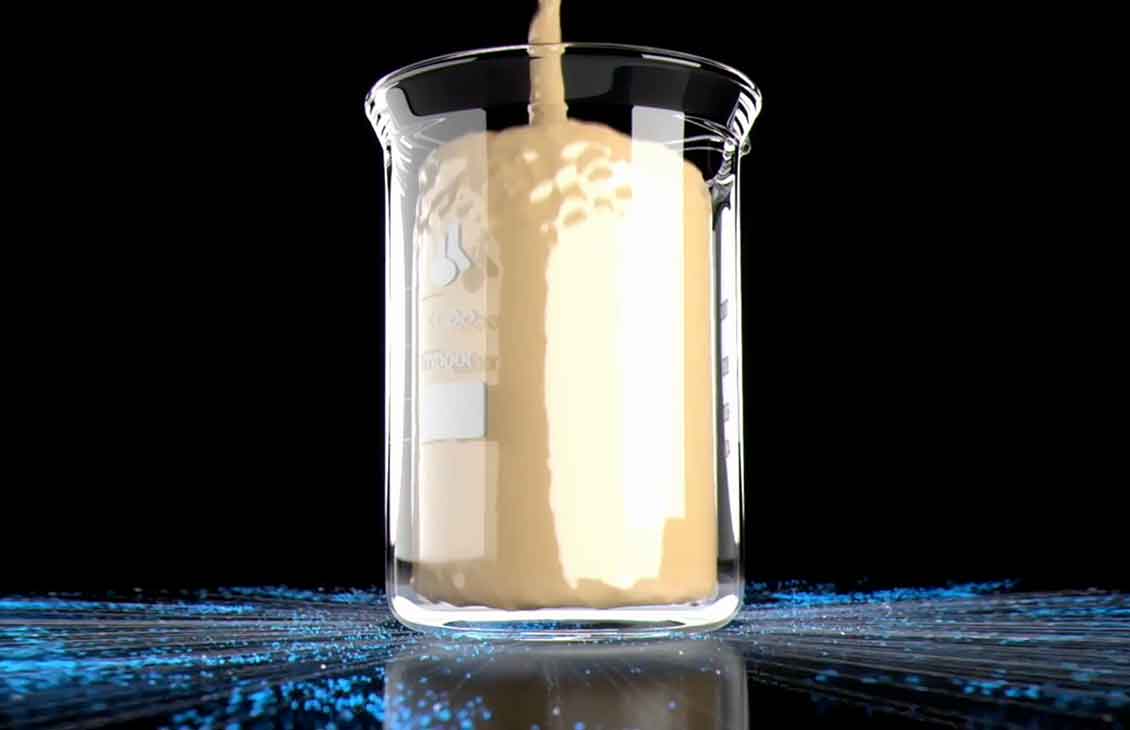 Container shown light brown fluid on top of a table with blue splash