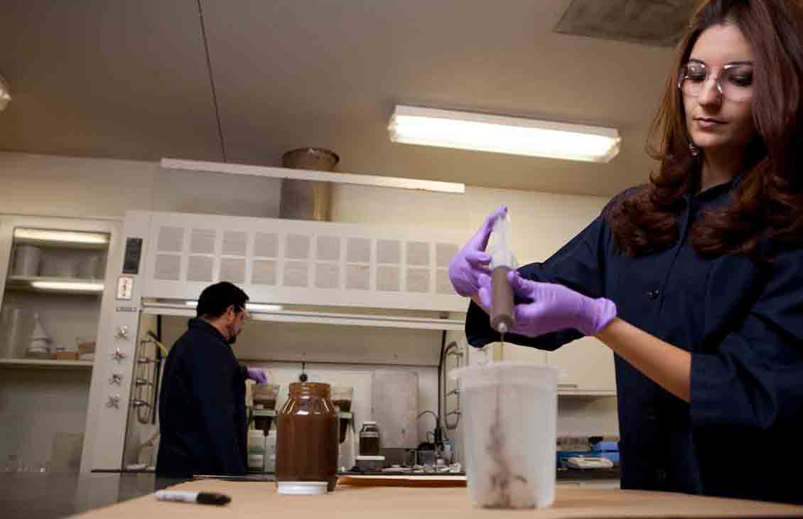 Two technicians working in a drilling fluids lab