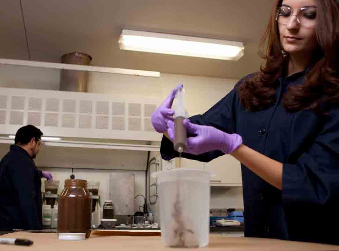 Two technicians working in a drilling fluids lab