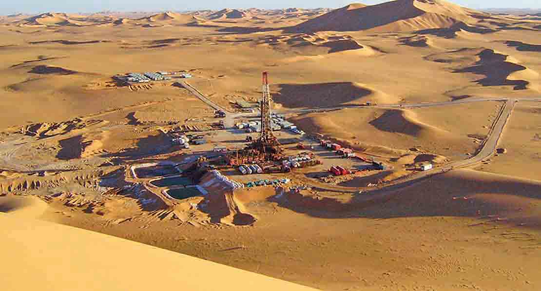 Aerial view of rig site in the desert.