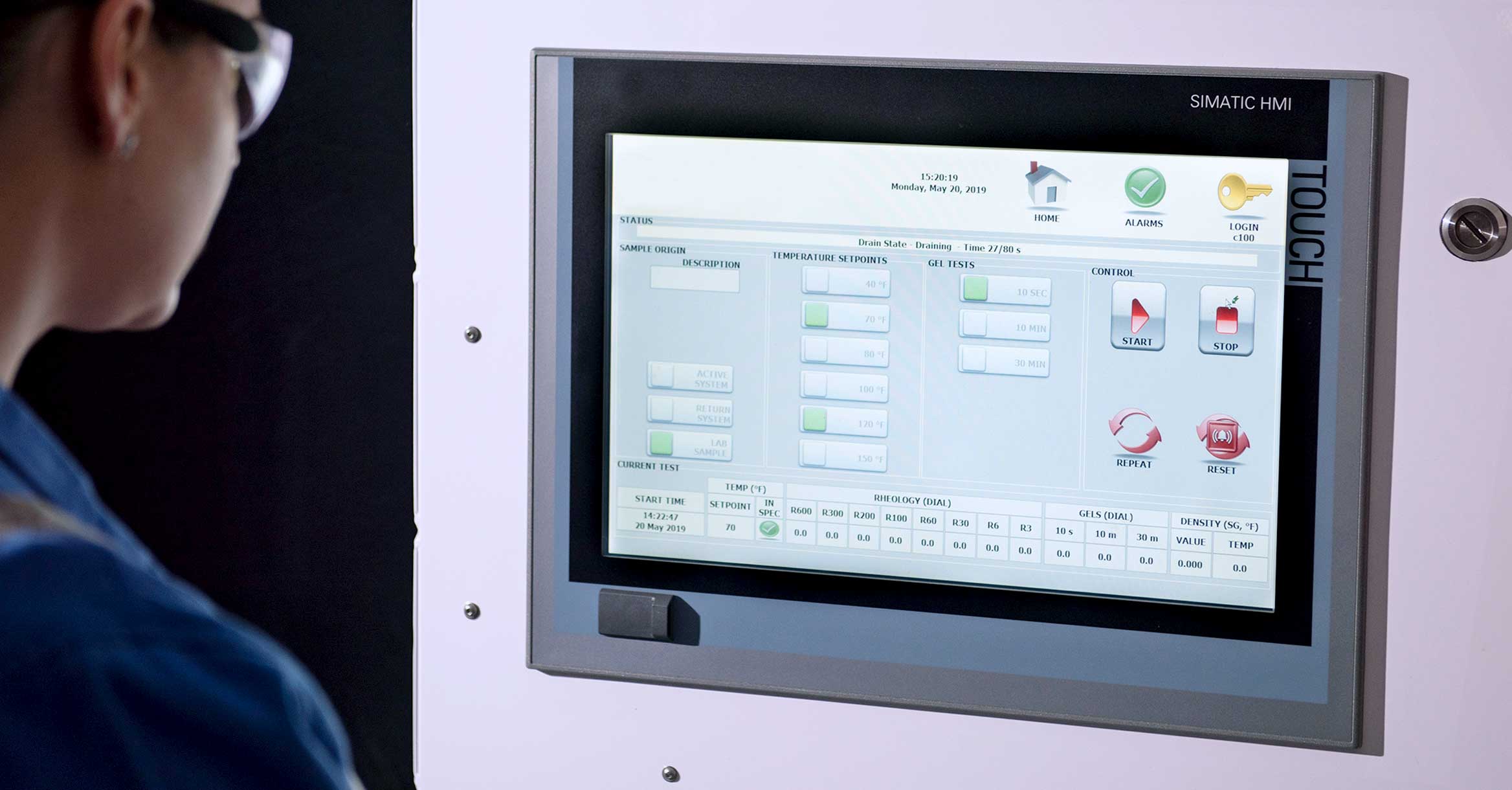 Operator looks at a computer screen with rheological tests displayed.