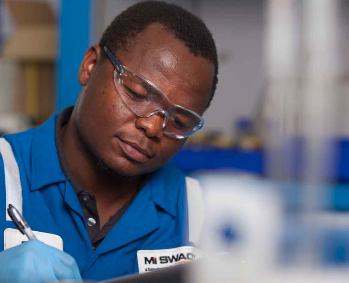 Lab worker writing down test results