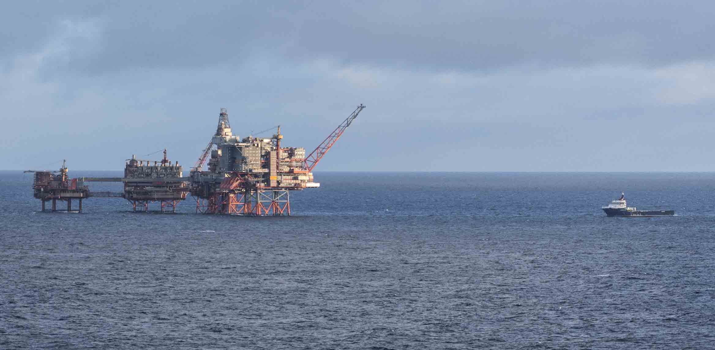 Photo of an offshore oil platform and supply boat in the North Sea.  