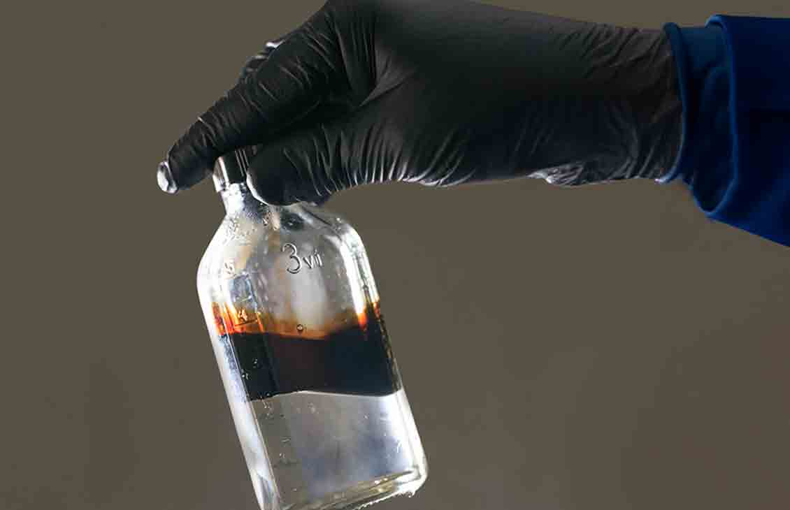 Bottle test shows effective separation of oil from produced water by WT-11033.
