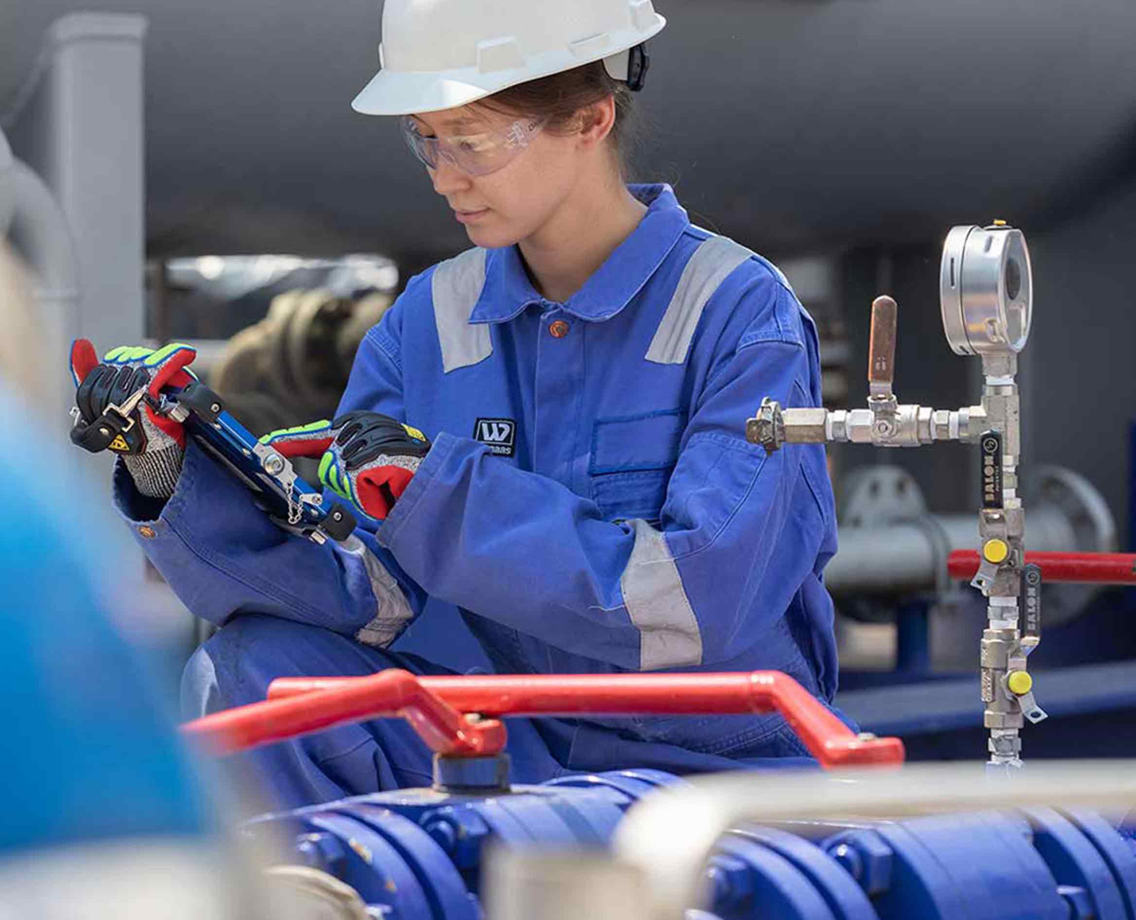 Schlumberger field operator near oil treatment unit.
