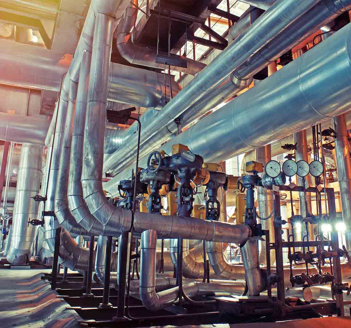 Equipment, cables and piping as found inside of a modern industrial plant