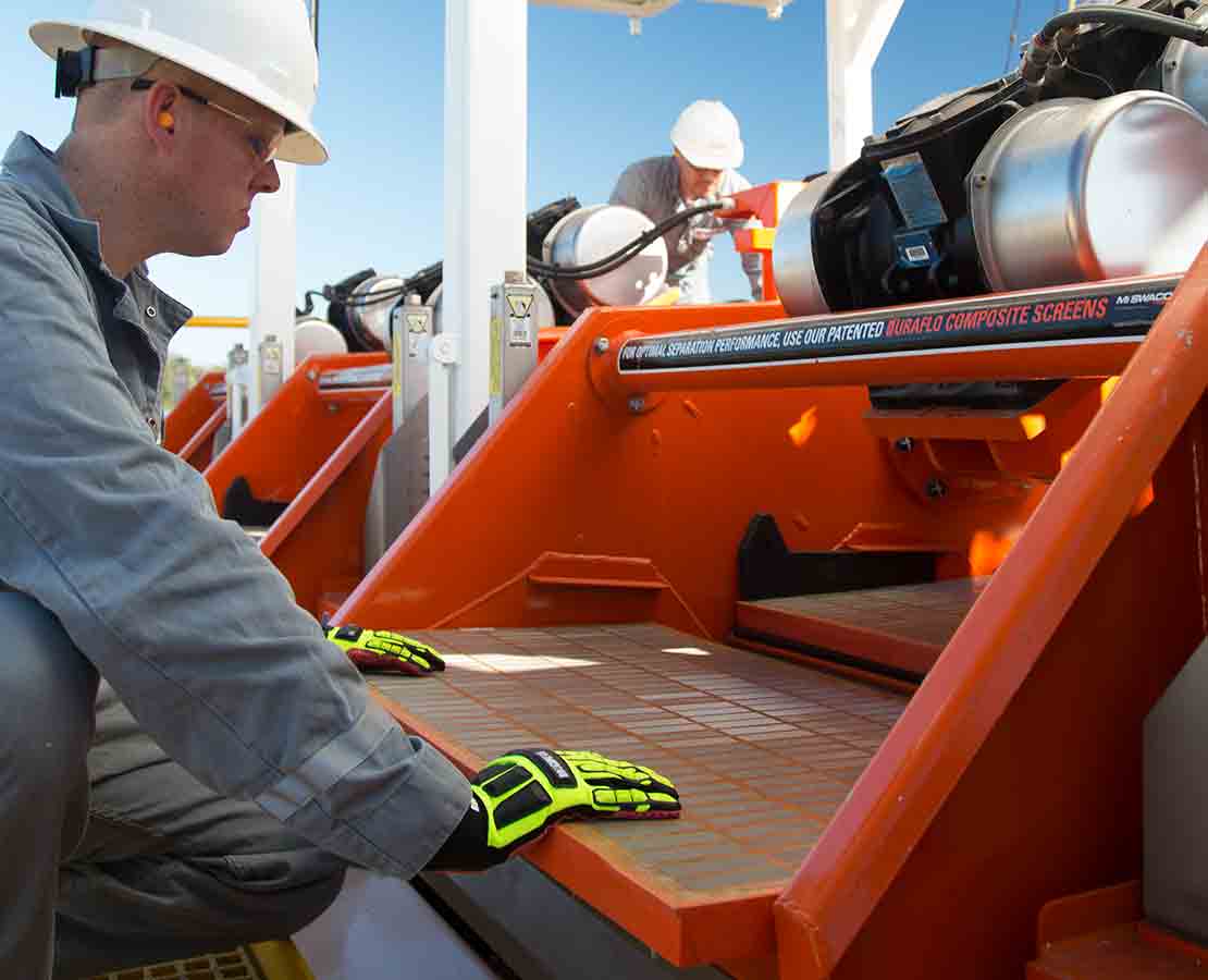 Worker Looking at MONGOOSE PRO dynamic dual-motion shale shaker