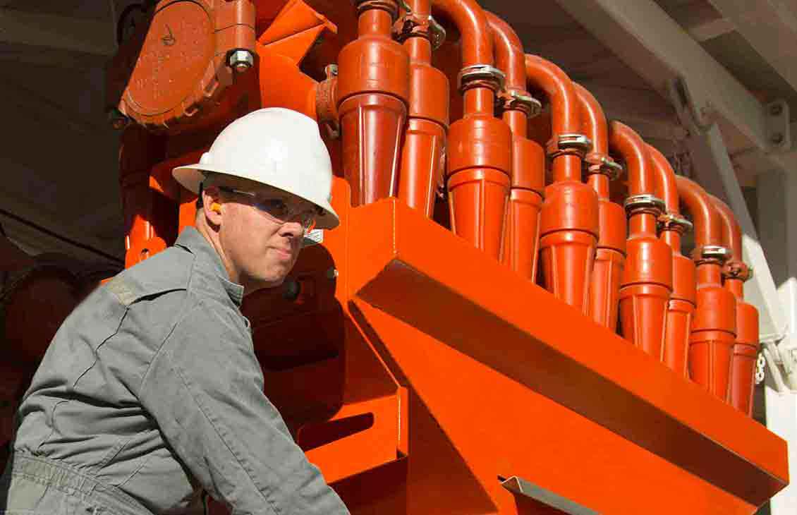 Man Performing Maintenance Checks on Mud Cleaner