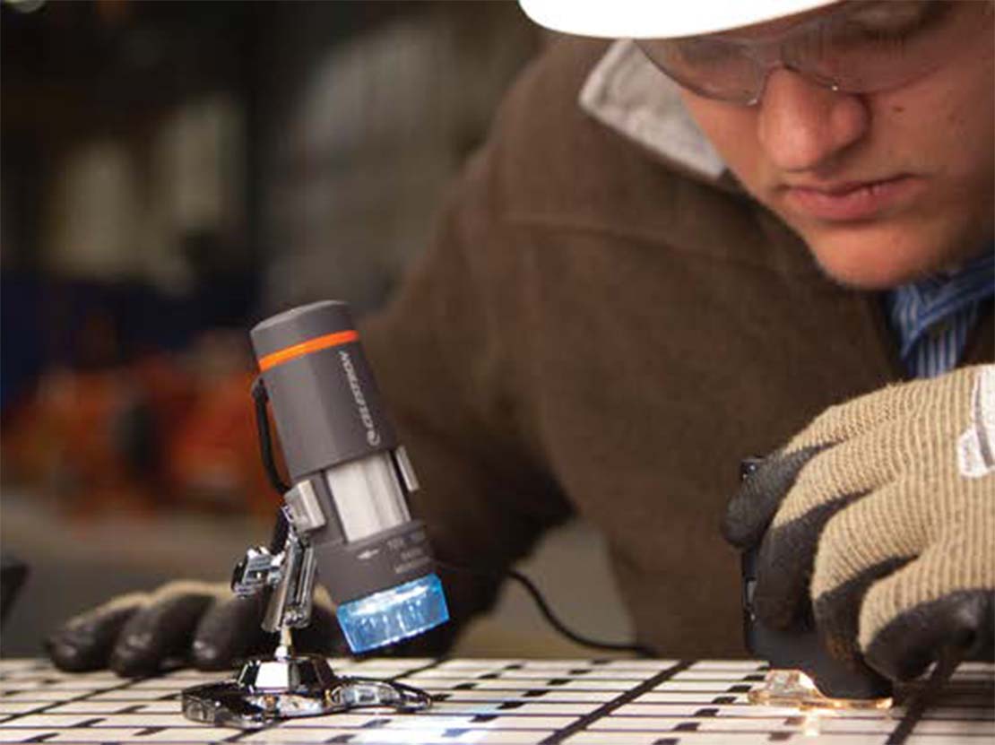 M-I SWACO employee looking closely at shaker screen.