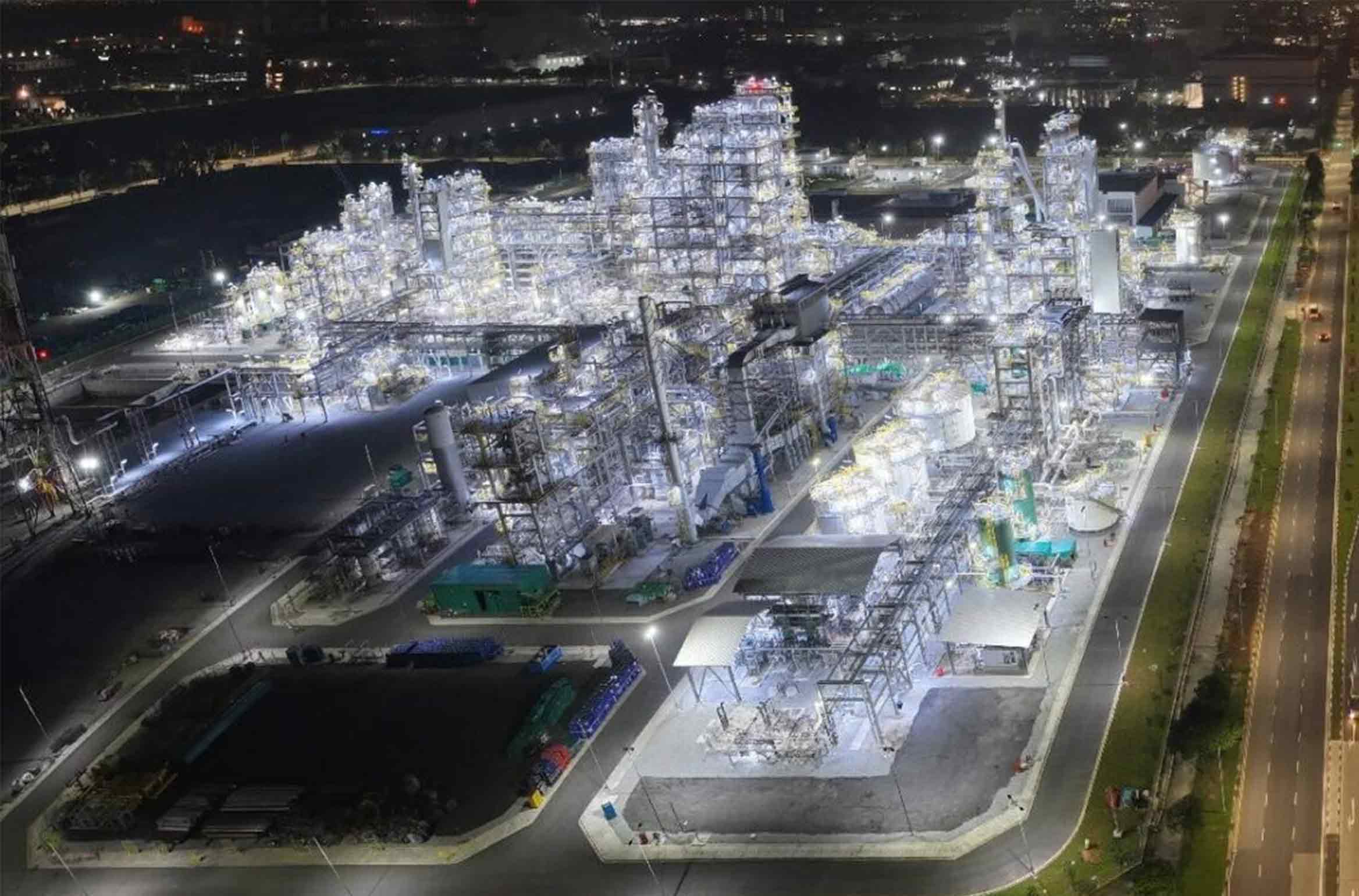 Illuminated chemical plant at night.