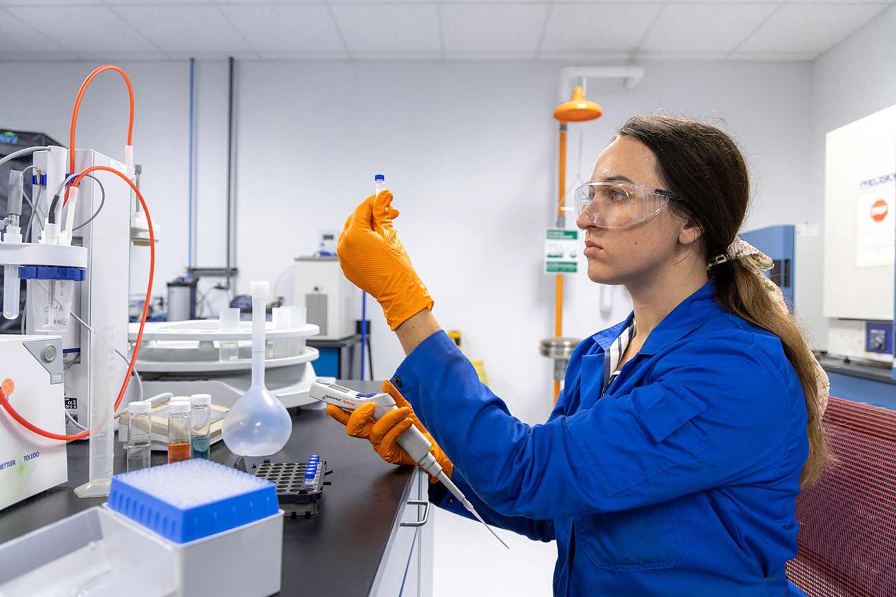 Woman in a production chemistry lab.