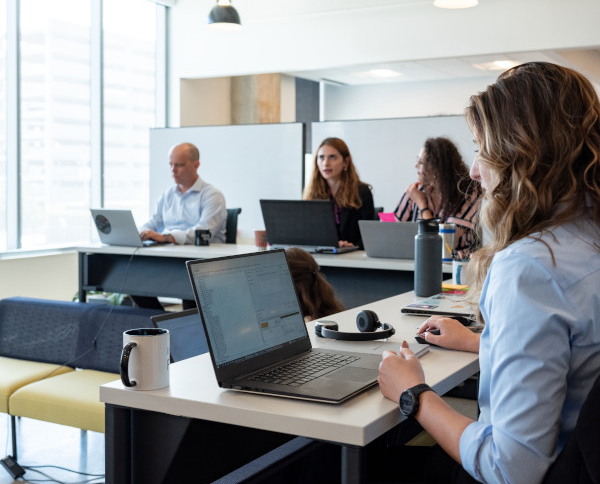 Image of people using computers at a desk