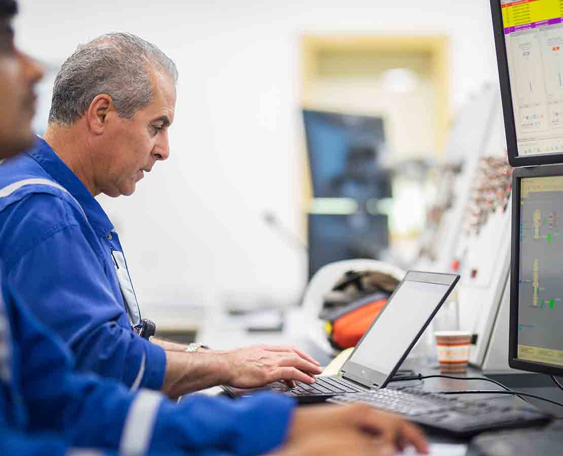 Schlumberger workers reading data to provide quantitative intelligence.
