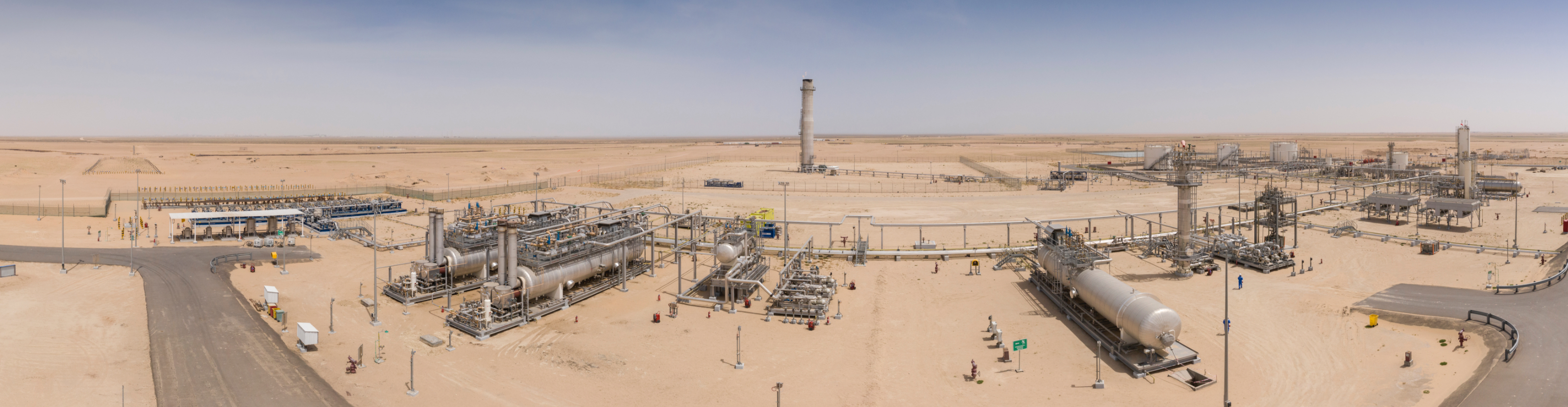 A desert processing facility with electrostatic oil treaters and other equipment.