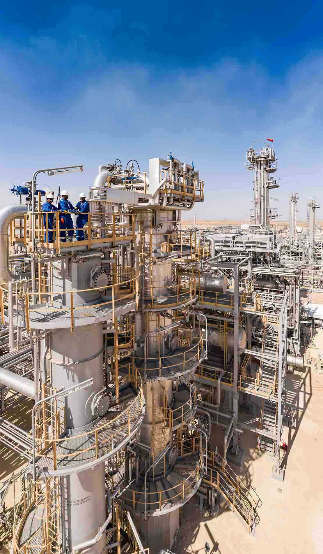 Workers on top of a processing facility.