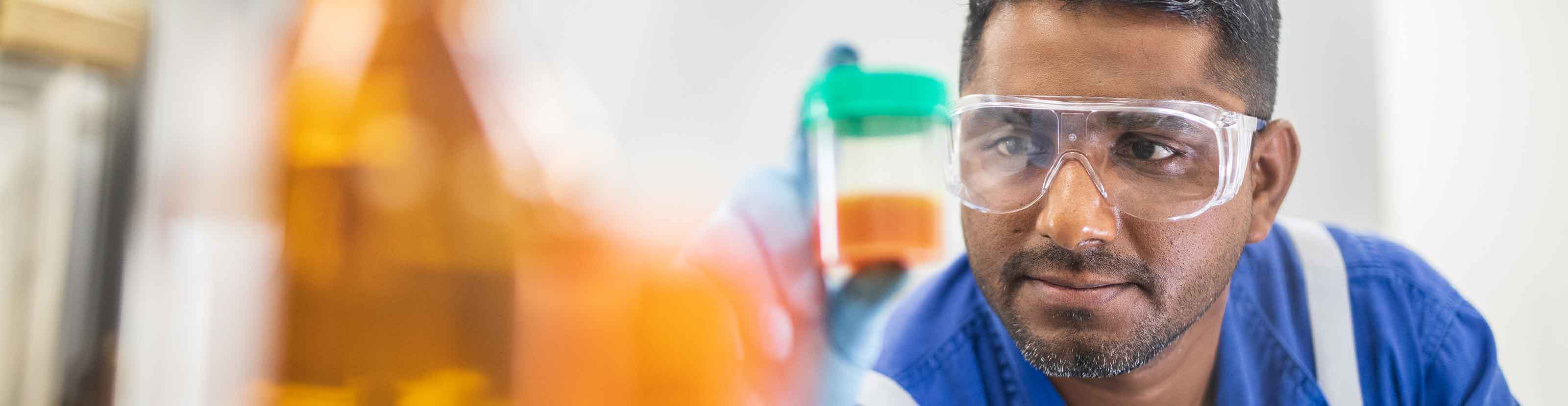 Operator examining injection fluids.