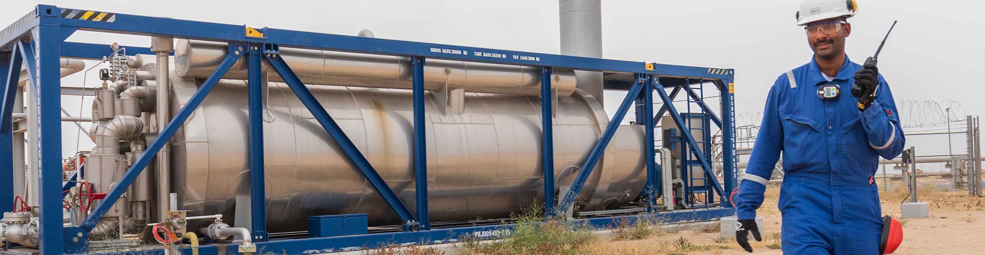 Schlumberger field worker monitoring an early production facility.