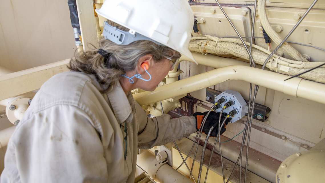 person checking compressor equipment