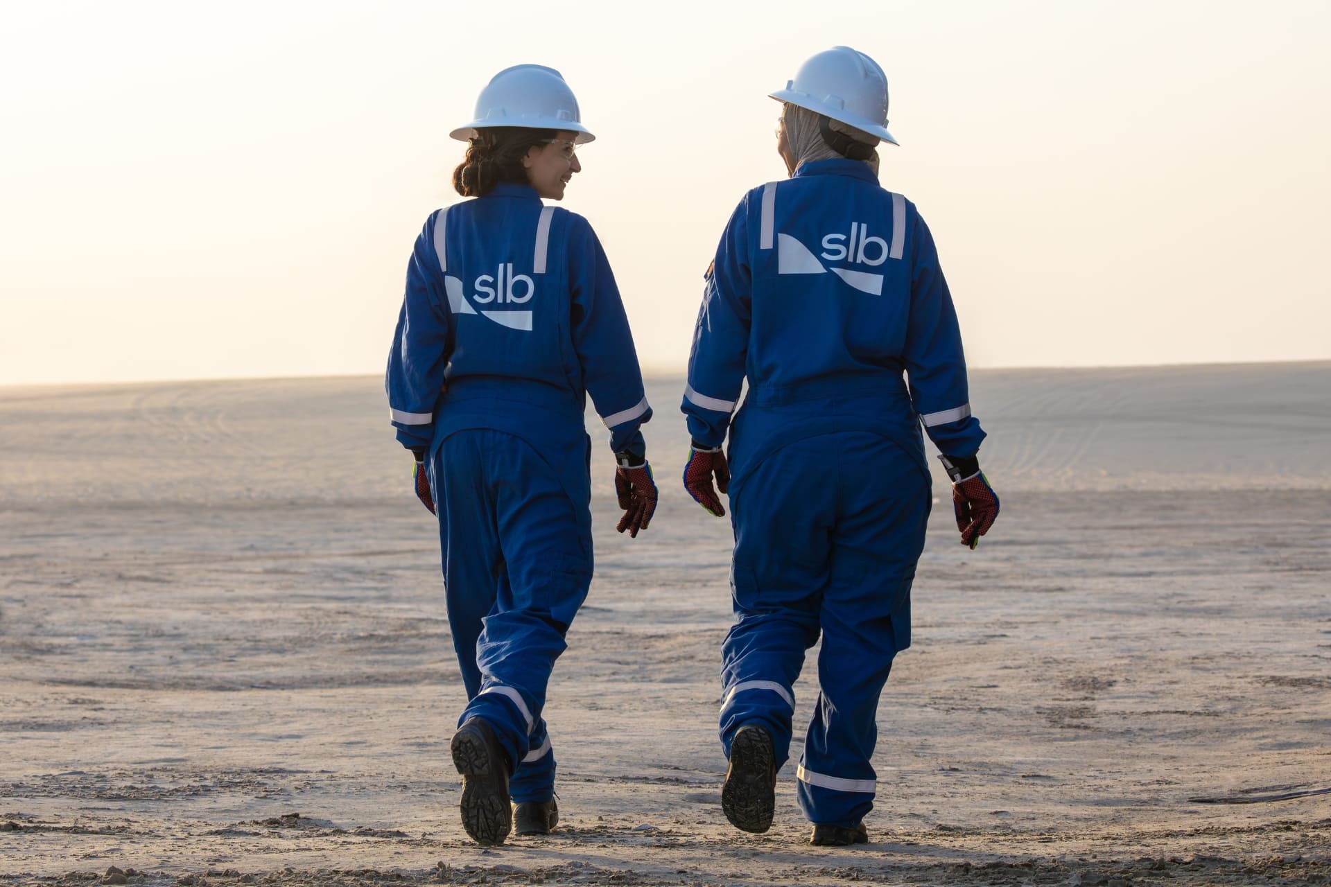 Photo of two women walking in the desert in the Middle East.