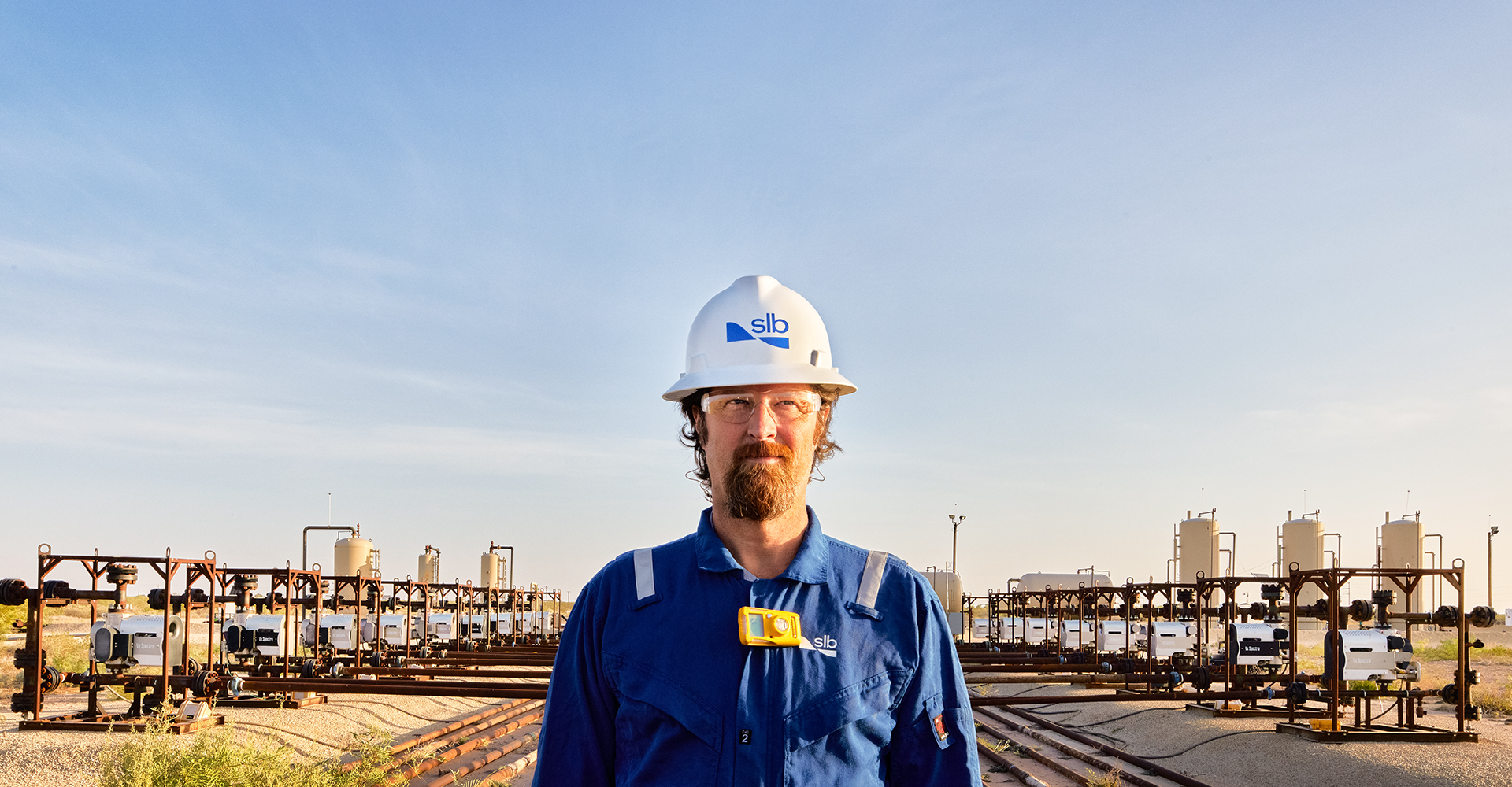 SLB employee at a surface well testing site.