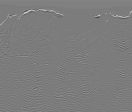 Revolution seismic data image shows an enhanced stack from a comparable wide-azimuth dataset with FWI plus subsalt update. 