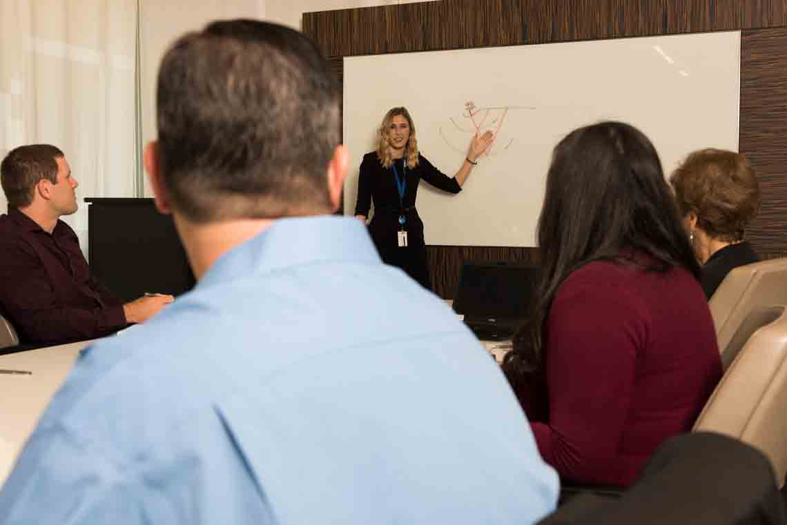 Conference room setting with presenter
