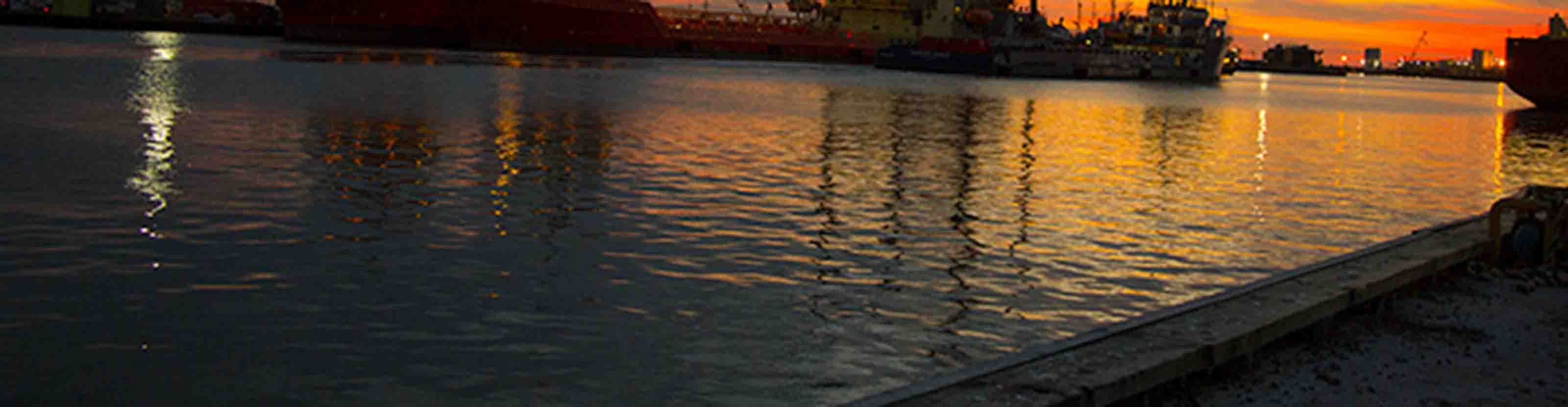 Water in shipyard at sunset.