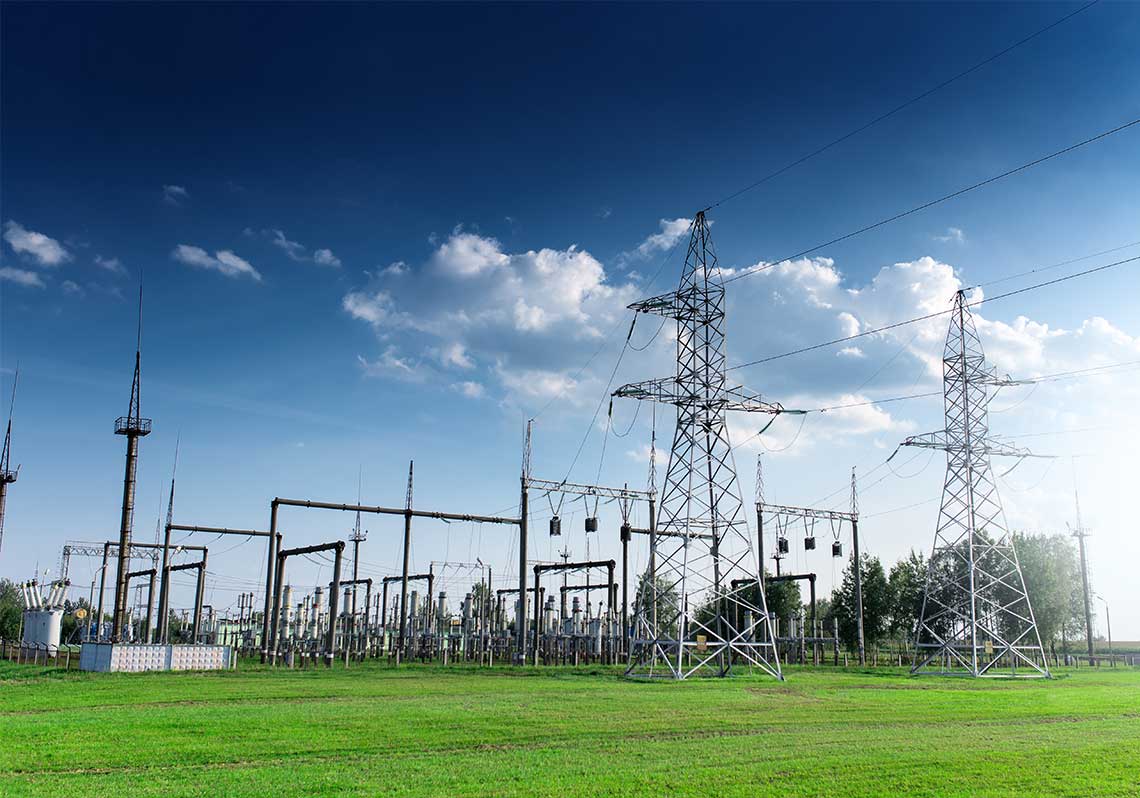 Photo of a power station against blue sky at daytime.