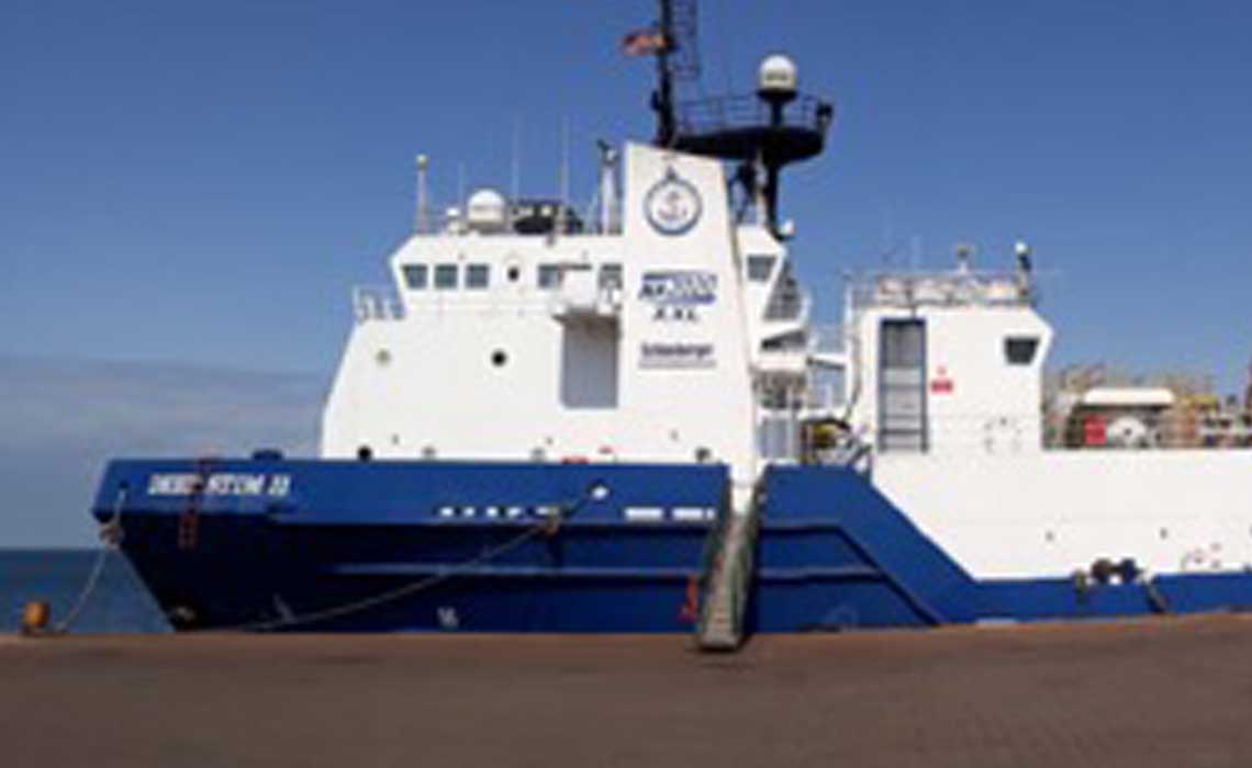 Blue-and-white DeepSTIM II vessel at the dock. 