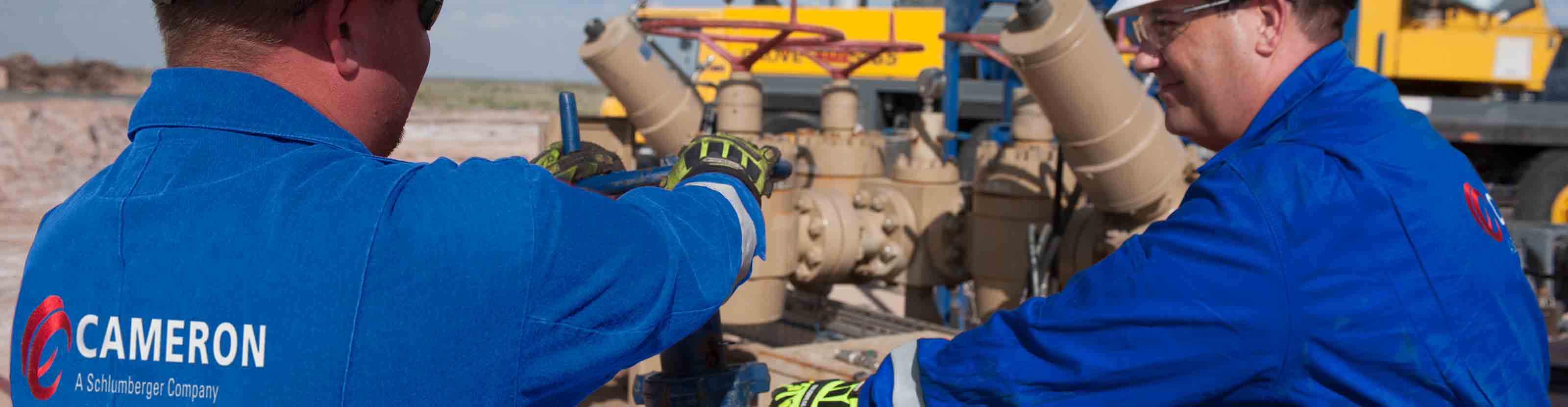 Two Cameron Workers Inspecting the Flowback Well Cleanup Equipment