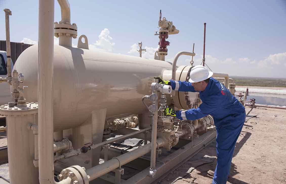 Cameron Worker Performing Maintenance Checks on Production Testing Measurements Equipment in the Field