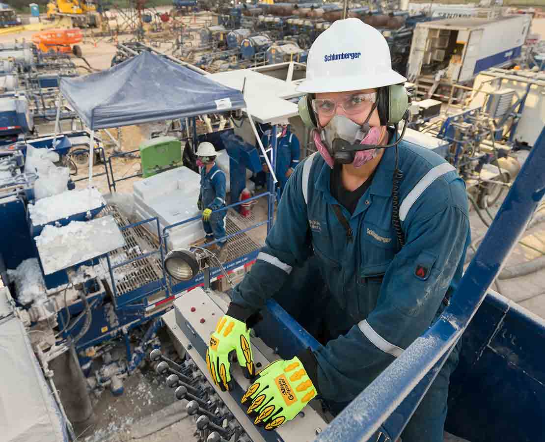 Schlumberger worker on rigsite during fracturing services operation.
