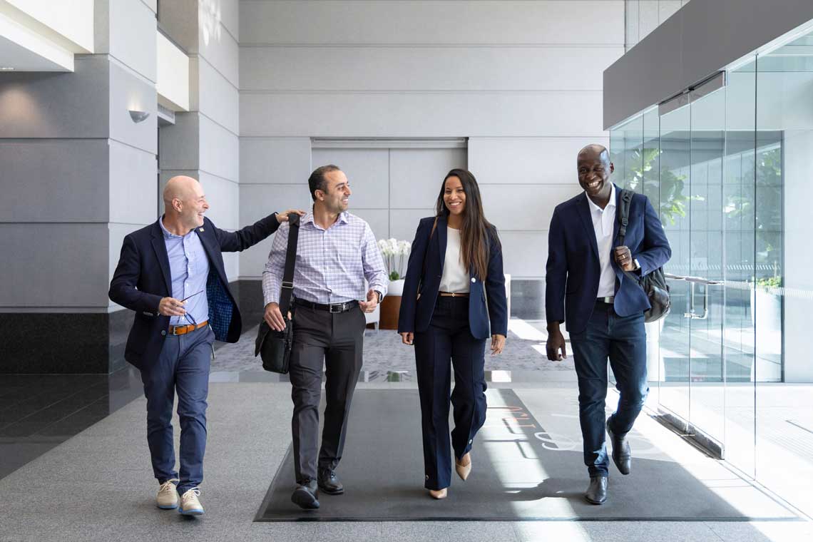Team members walking together through an office