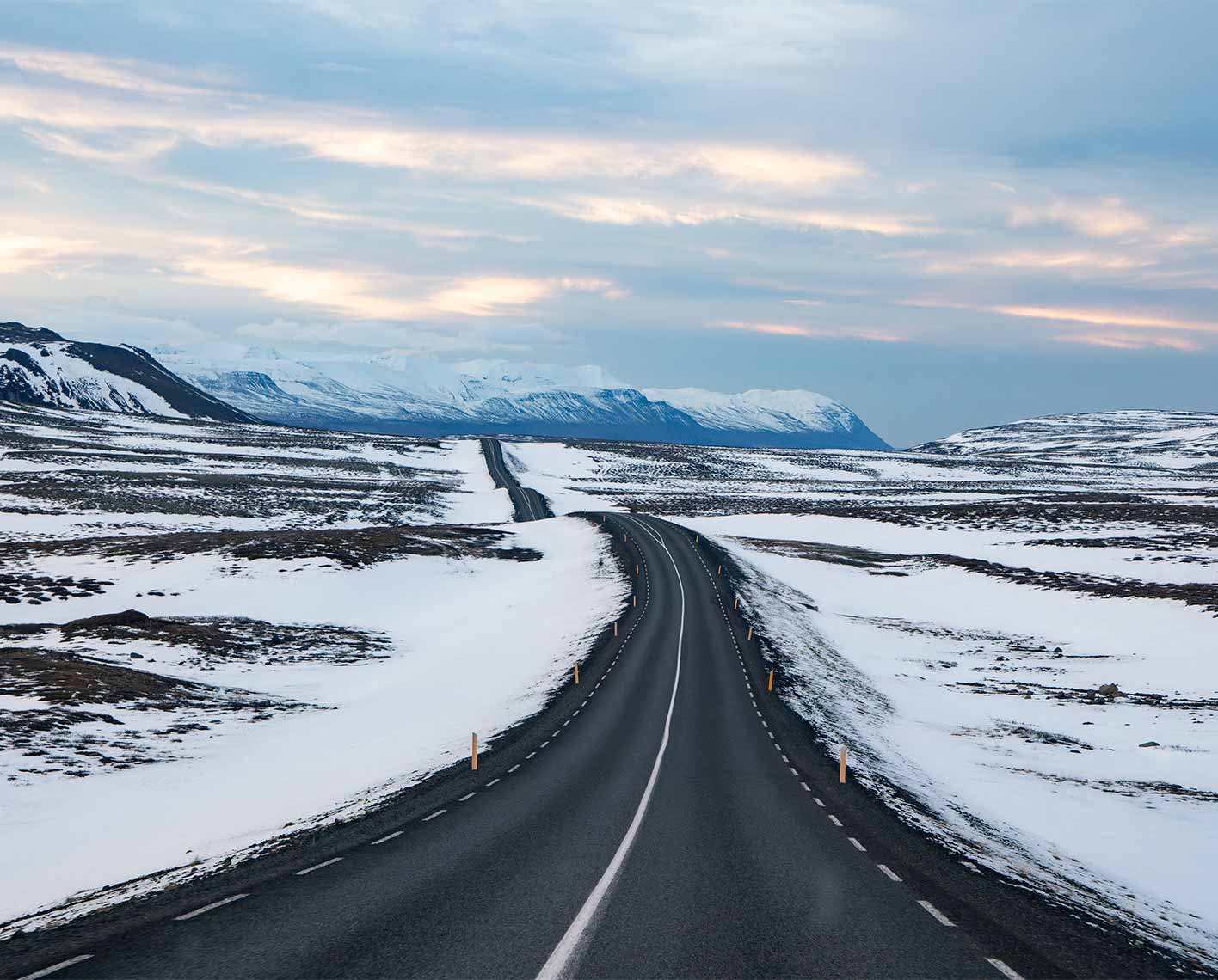 A road during wintertime with snow on the ground