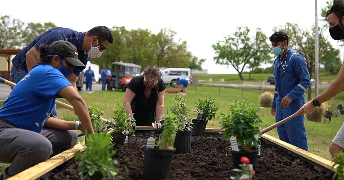 Volunteers creating a butterfly habitat at a Schlumberger facility in Oklahoma.