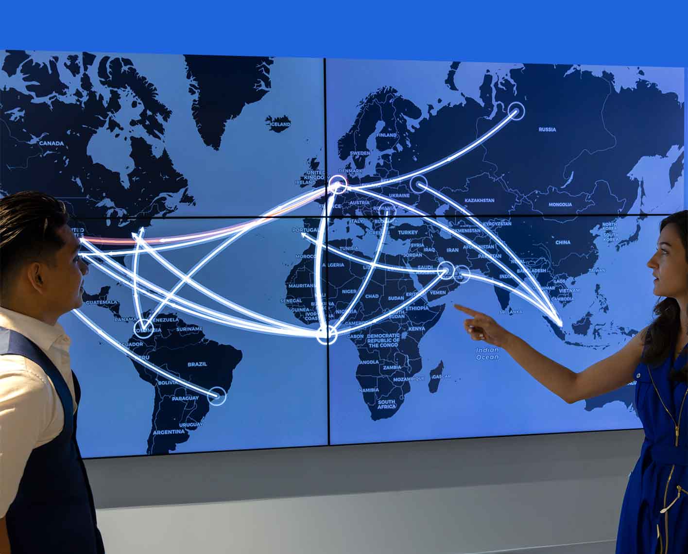 Two employees analyzing a global world map