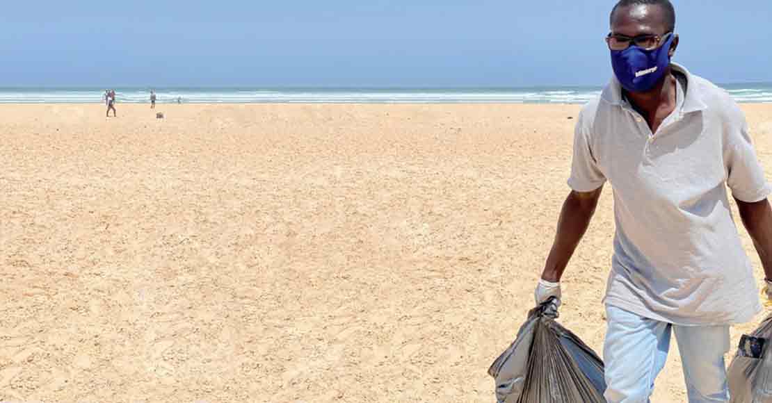 Schlumberger volunteer cleaning a beach in Senegal, Africa.