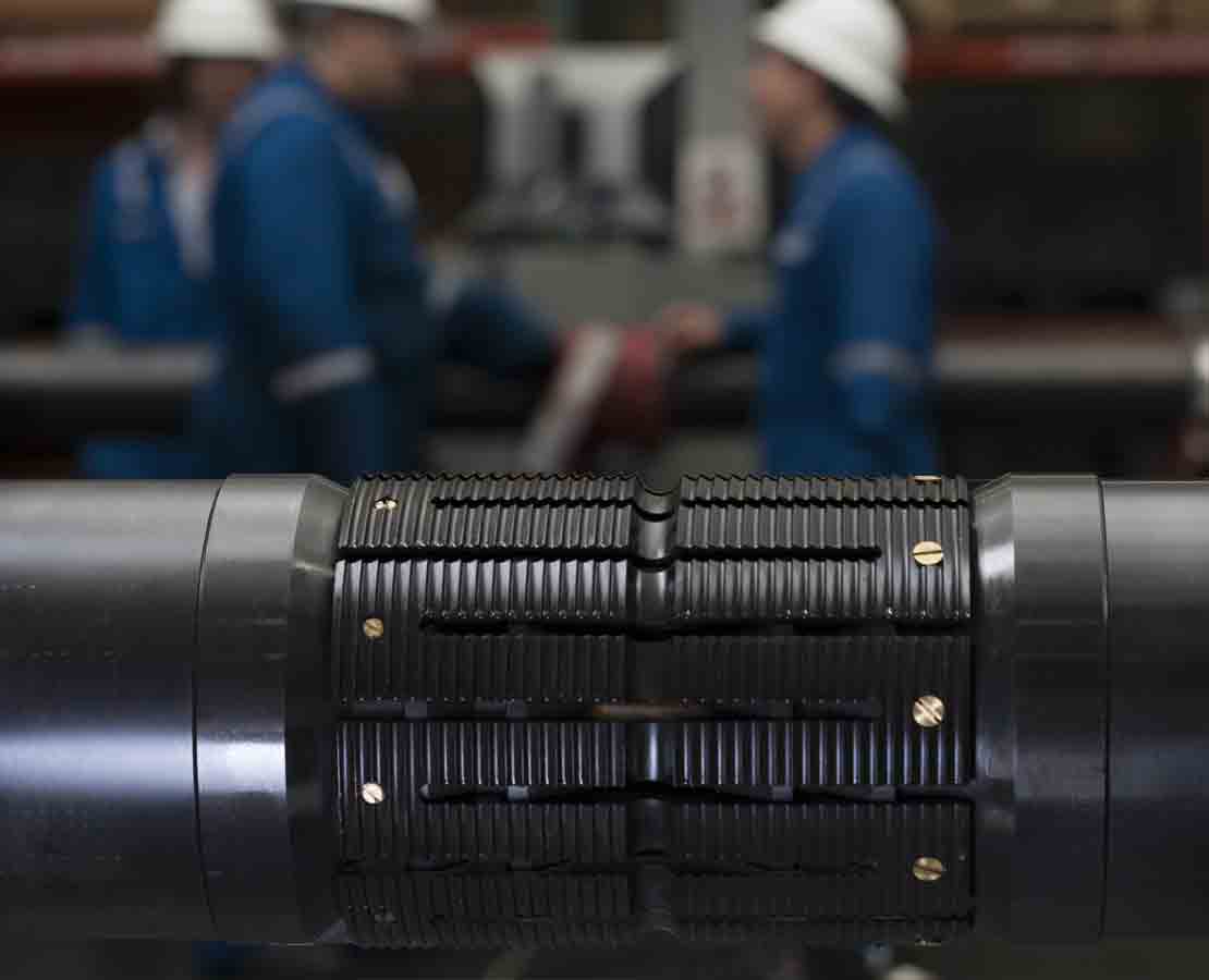 Schlumberger workers in the background and CERTIS high-integrity reservoir test isolation system in the foreground.