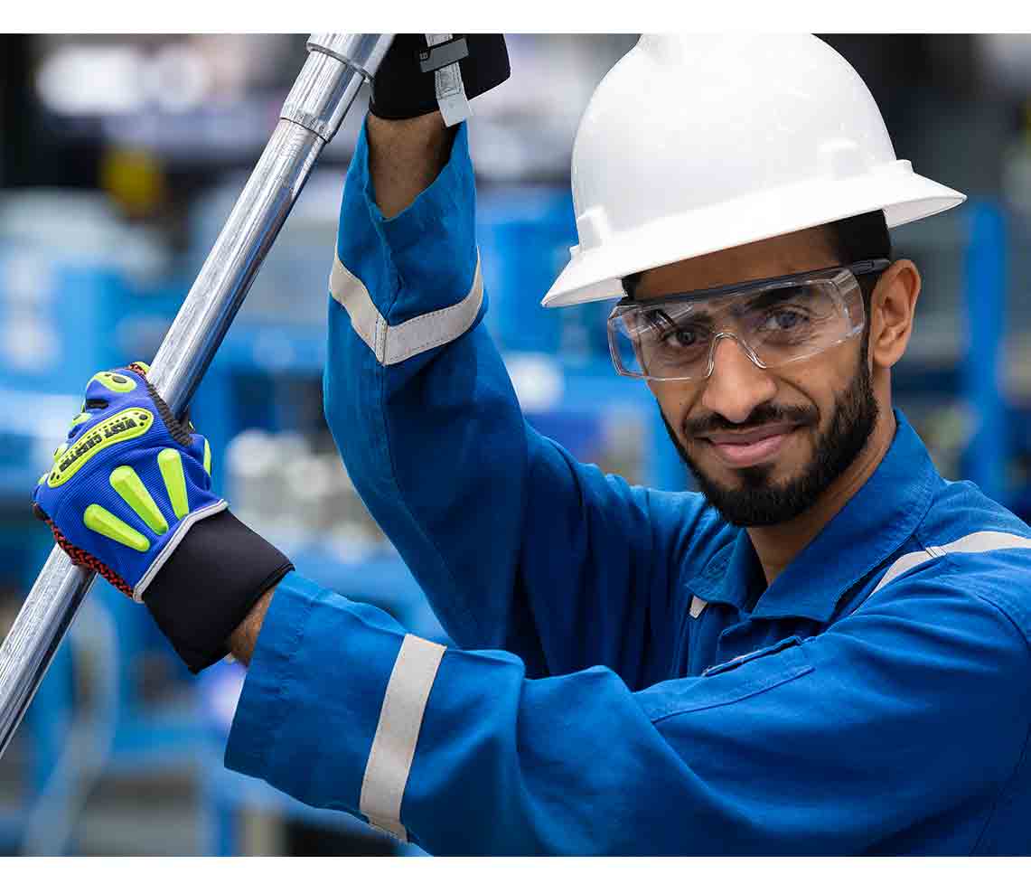 Man in hardhat working with surface testing equipment.