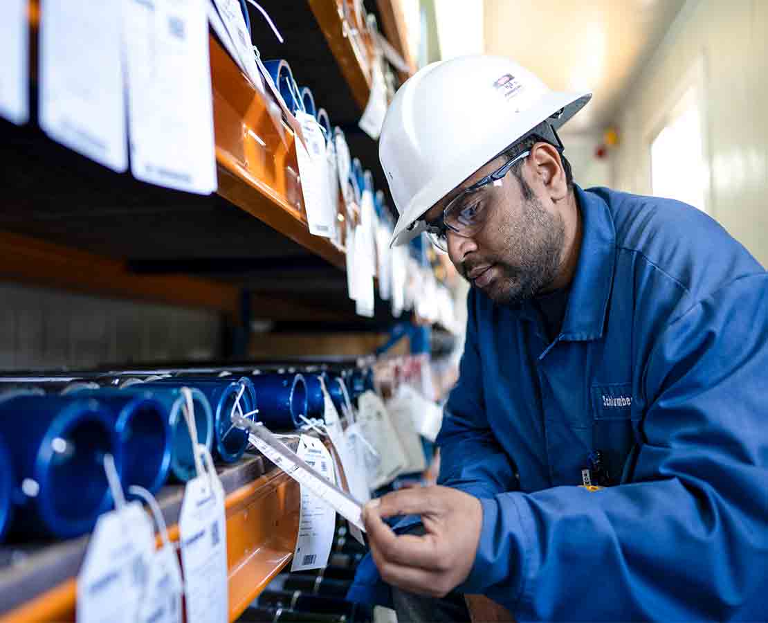Employee checking sample canisters  in warehouse