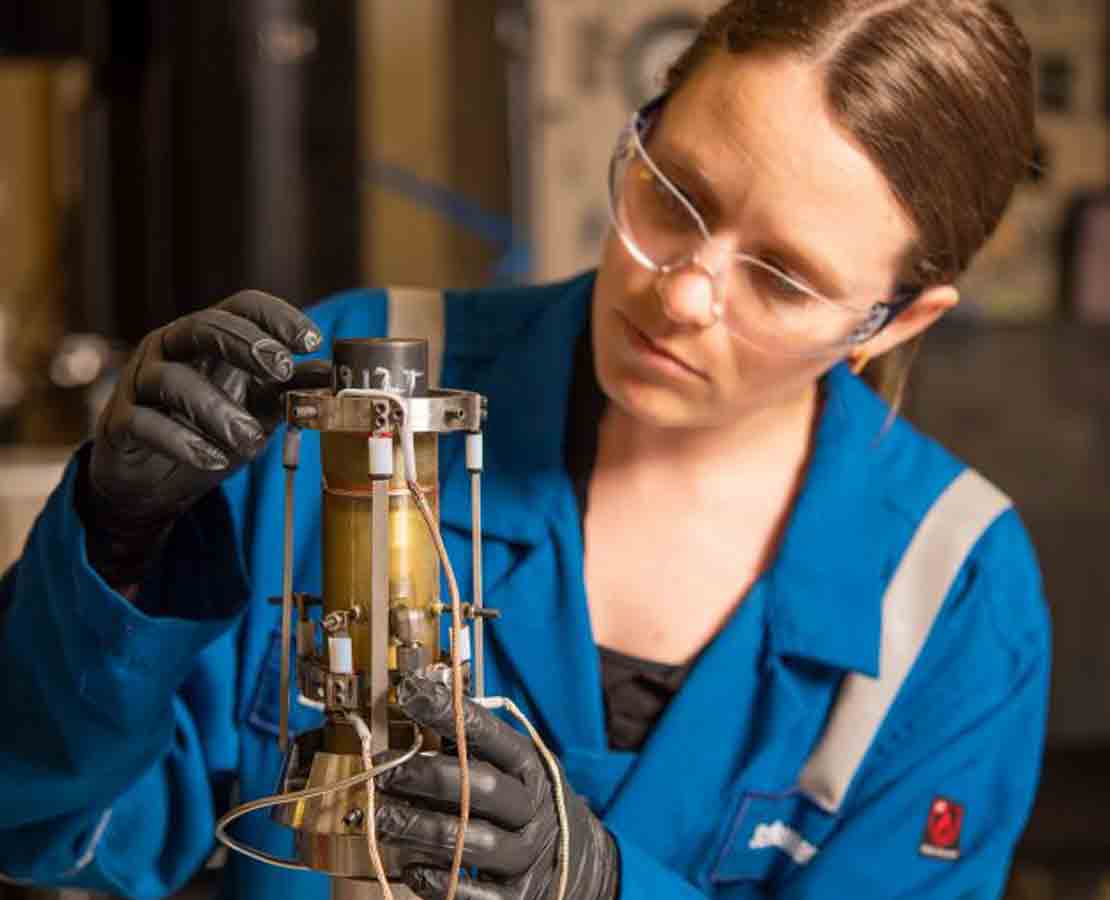 Employee performing core analysis in a lab